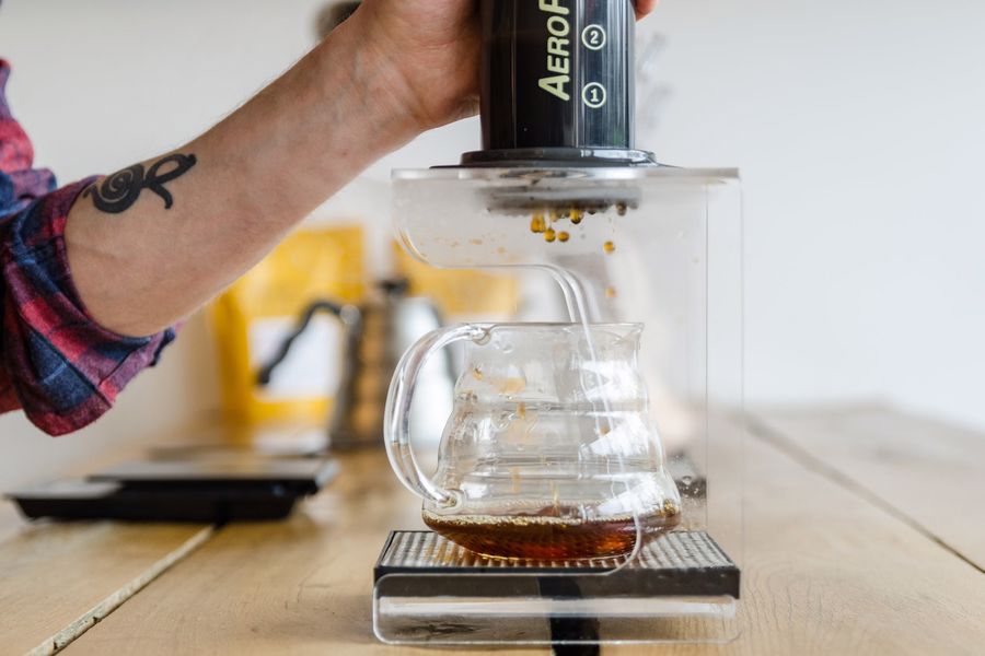 Person brewing coffee using an Aeropress