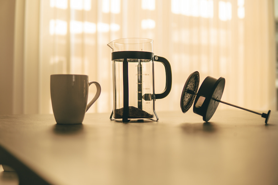 An image of a coffee mug and a french press