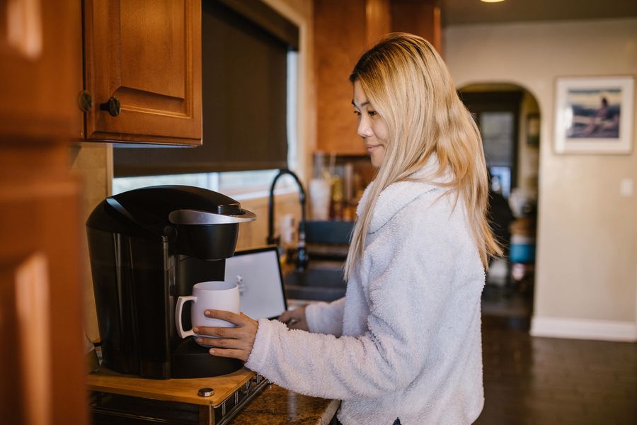 Woman using a Keurig coffee machine
