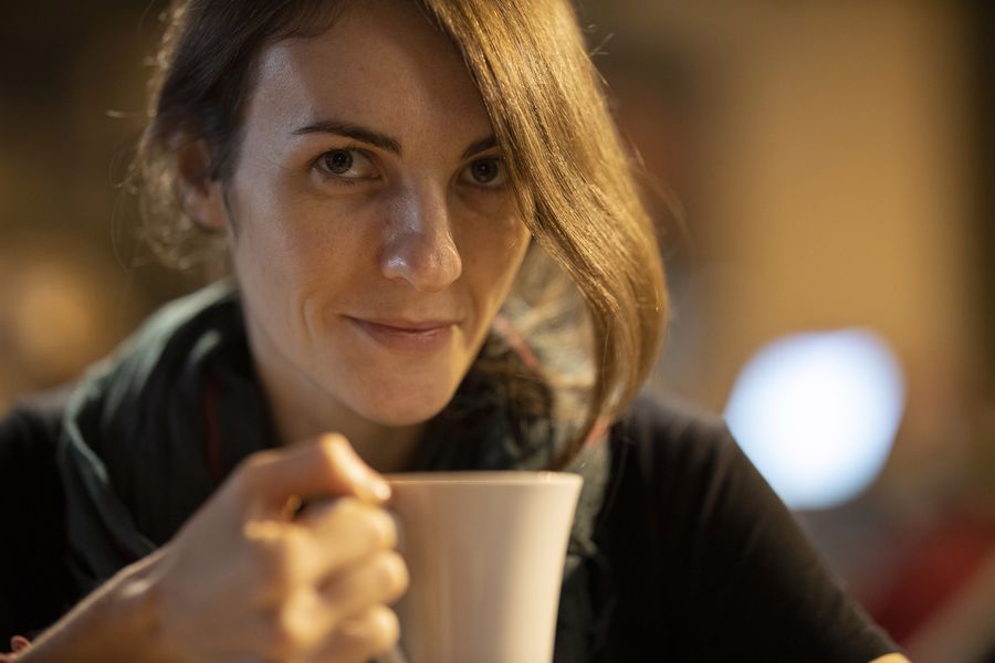 Woman about to take a sip of her coffee
