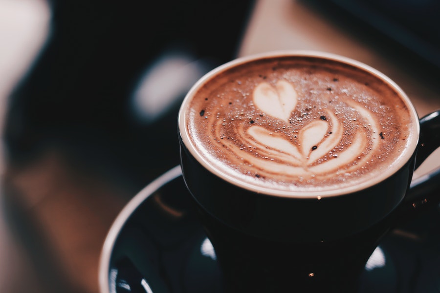 Coffee in a black mug with latte art