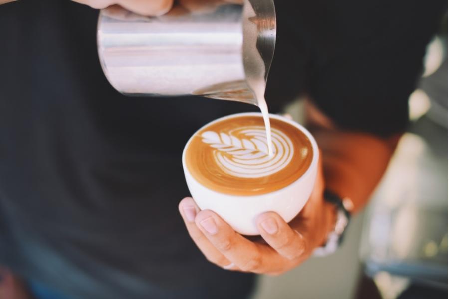 An image of a barista making latte art