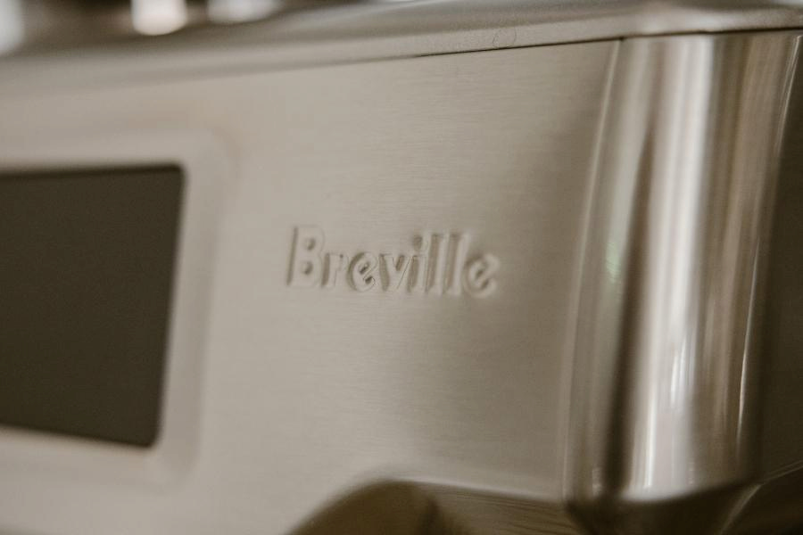 Close-up image of Breville's logo in a coffee maker