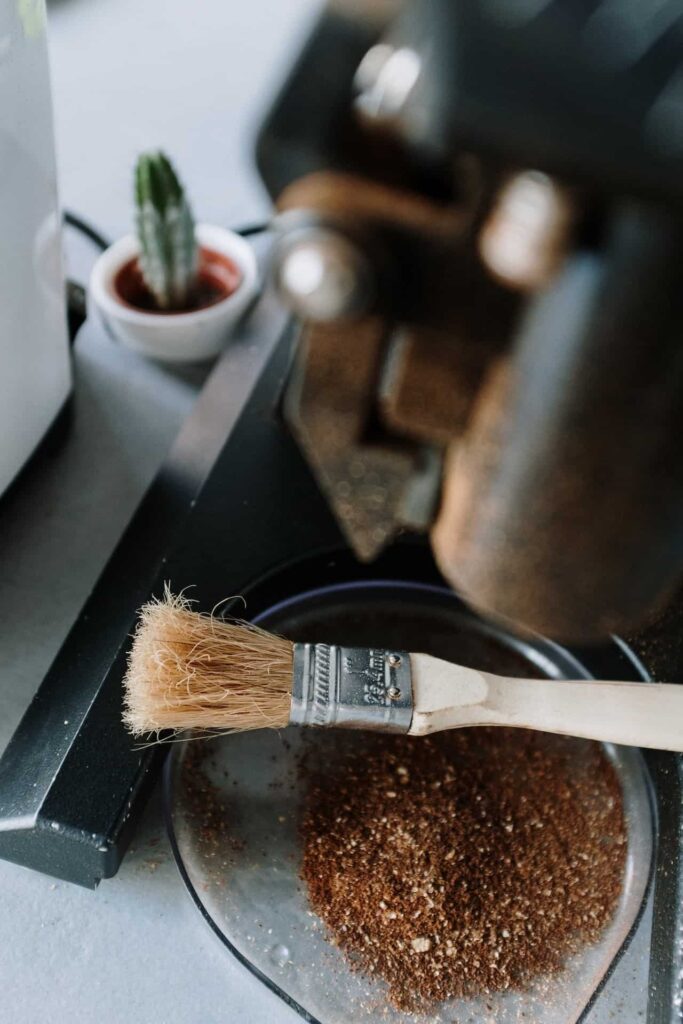 An image of coffee grounds and brush