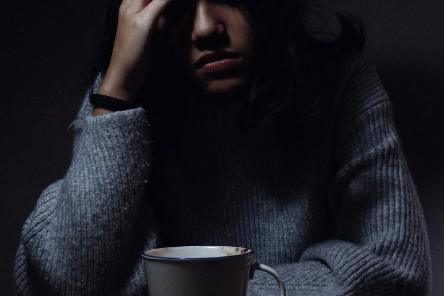 An image of woman having headache after drinking coffee
