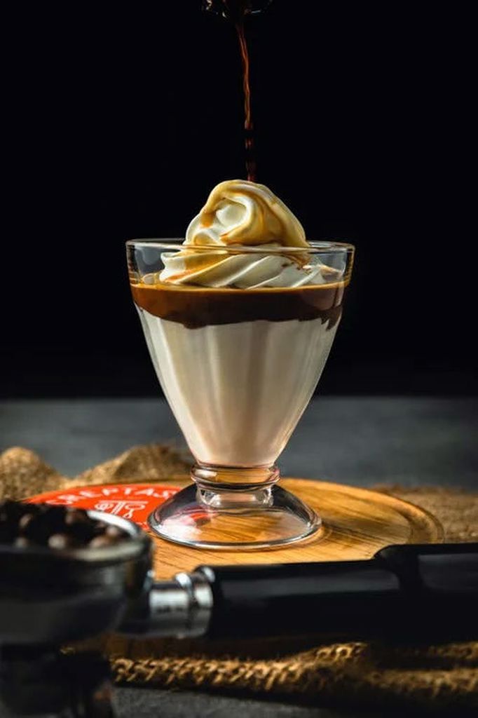 Ice cream sundae being poured with a coffee syrup