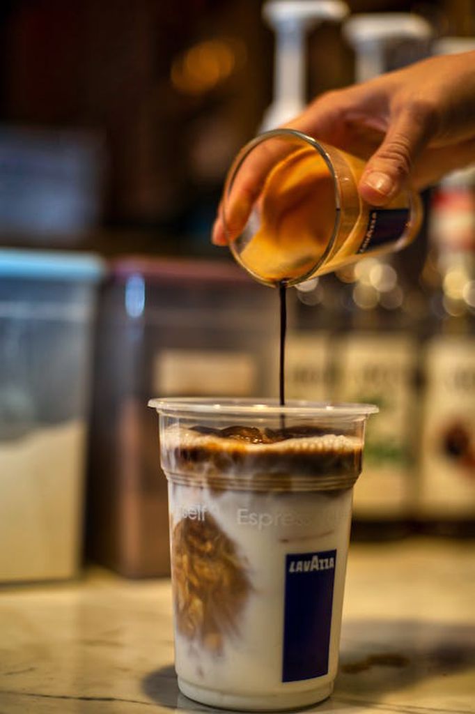 Iced coffee being added with coffee syrup